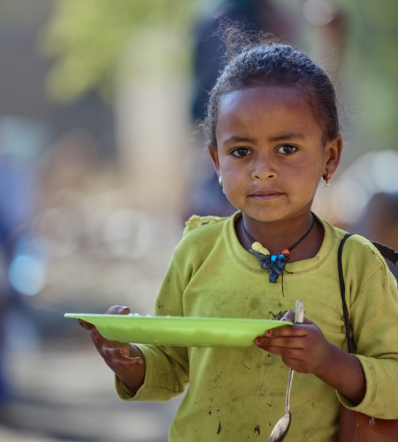 child eating Mary's Meals in Ethiopia
