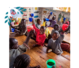 Children holding mugs up in the classroom